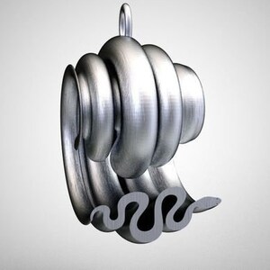 May include: A silver pendant featuring a stylised wave design with a coiled, spiral shape at the top. The pendant has a smooth, metallic finish.