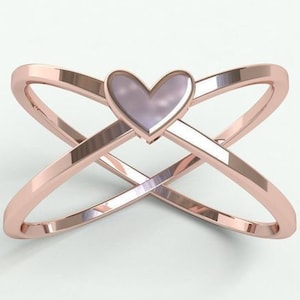 K&ouml;nnte beinhalten: Ring aus Ros&eacute;gold mit einem Design aus &uuml;berlappenden B&auml;ndern. Der Ring hat ein herzf&ouml;rmiges Mittelst&uuml;ck mit einem hellvioletten Farbton. Das Design des Bandes erzeugt eine X-Form und verleiht dem Schmuck eine moderne Note.
