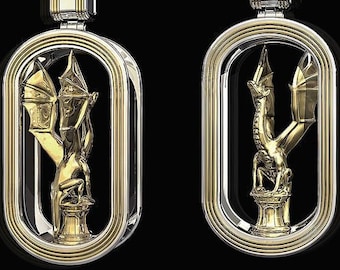 May include: Two gold and silver dragon pendants. Each pendant features a detailed dragon figure within an oval frame. The dragon is perched on a pedestal with outstretched wings. The pendants have a polished finish and are set against a black background.