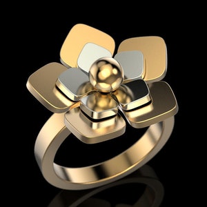 May include: A gold ring with a flower-shaped design. The flower is made of multiple layers of gold and silver metal, with a round gold center.