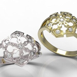 Könnte beinhalten: Zwei Ringe mit floralem Design, einer in Silber und der andere in Gold. Jeder Ring hat eine zentrale Anordnung kleiner, klarer Edelsteine und ein dekoratives durchbrochenes Muster. Die Ringe sind vor einem weißen Hintergrund platziert.