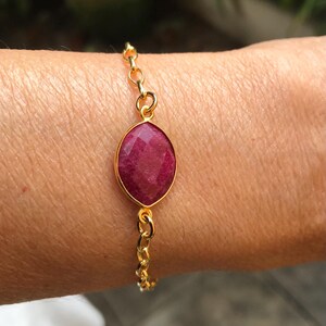 May include: A white ceramic mug with a black handle and the text "But First, Coffee" in a bold, black font. The mug is set against a blurred background, suggesting a cozy setting. The mug appears to be approximately 4 inches tall.