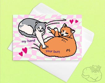 May include: A humorous greeting card featuring two cartoon cats. One grey and white cat reaches towards the orange cat's rear. The card has the text "my hand" and "your butt". The background is a pink and green checkered pattern with heart shapes.
