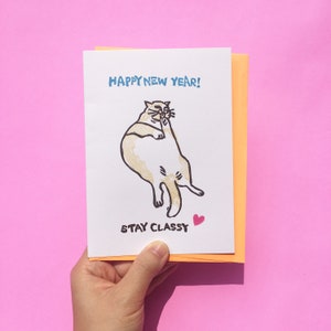 Carte de Noël lécher un chat chic, séjour de bonne année - Noël mème chat, carte mème nouvel an, carte mème vacances, carte drôle de chat linogravure