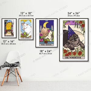 May include: Four framed prints of cat tarot cards. The cards are titled "The High Priestess", "The Fool", "The Moon", and "The Magician". Each card features a cat in a different pose and setting. The cards are framed in black frames and are hung on a white wall.