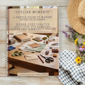 May include: A spiral-bound book titled OFFLINE MOMENTS A GENTLE GUIDE TO MAKING WITHOUT SCREENS SCREEN-FREE CREATIVE ACTIVITIES FOR FAMILIES, CARERS AND COMMUNITY GROUPS with a cover image of a wooden table featuring craft supplies and tools.