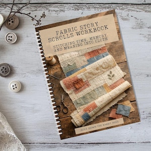 May include: A spiral-bound workbook titled Fabric Story Scrolls Workbook: Stitching Time, Memory and Meaning into Cloth by Alice Down the Rabbit Hole. The cover features a photograph of patchwork fabric, scissors, and thread on a wooden surface.