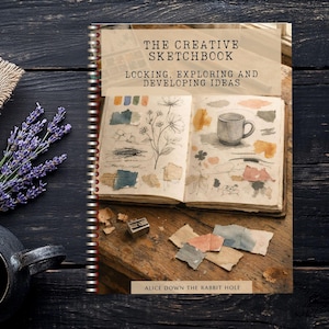 May include: A spiral-bound book titled The Creative Sketchbook: Locking, Exploring and Developing Ideas by Alice Down The Rabbit Hole. The cover features an open sketchbook with watercolour illustrations of flowers, a mug, and paint swatches.