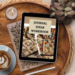 May include: A digital tablet displaying a workbook cover with the title "Journal Ideas Workbook". The cover features a collage of vintage journal pages and art supplies.