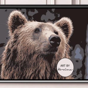 May include: A framed art print showing a close-up of a brown bear's face. The bear has thick, textured fur and a dark nose. The background is a mix of dark and light shades. The print is labeled "ART BY Karina".