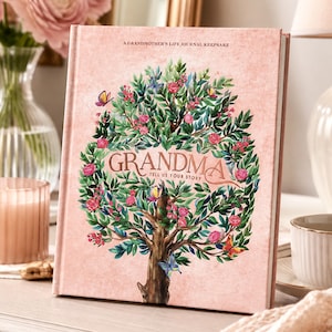 May include: A hardback journal with a light pink textured cover featuring a central illustration of a tree with green leaves, pink roses, and colourful butterflies. The text reads A GRANDMOTHER'S LIFE JOURNAL KEEPSAKE and GRANDMA TELL US YOUR STORY.