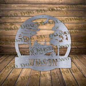 May include: Metal sign with a circular design featuring a tractor in a field with trees. The sign has a nameplate at the bottom with the name "WILSON".
