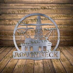 May include: A metal silhouette of an oil rig with the name "ROUGHNECK" below it. The silhouette is in a circle and is on a wooden background.