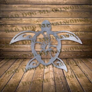 May include: Metal wall art of a turtle with a hibiscus flower in the center. The turtle is made of metal and has a rustic finish.