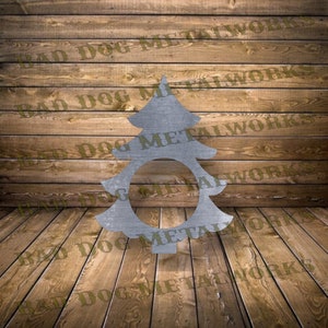May include: A metal Christmas tree cutout with a circle in the center. The tree is silver and has a rustic look. The background is a wood grain.