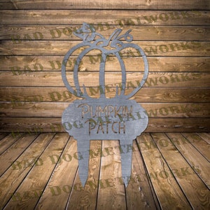 May include: Metal pumpkin patch sign with a pumpkin silhouette and the words "Pumpkin Patch" in a decorative font.