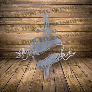 May include: A metal wall art piece depicting a heart pierced by a dagger with a banner wrapped around the heart. The piece is made of metal and has a silver finish.