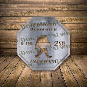May include: A silver metal sign with an octagonal shape. The sign features a silhouette of a Bigfoot holding a rifle, with the text "Protected by Squatch" and "Dog & The 2nd Amendment" around the image.