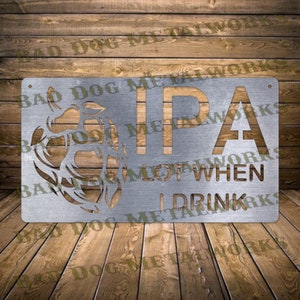 May include: A metal sign with a stylized hop design and the text "IPA I DRINK A LOT WHEN" in a rustic, distressed style.