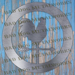 May include: A silver metal rooster weathervane with an arrow pointing to the right. The weathervane is mounted on a circular base with the text "BAD DOG METALWORKS" repeated around the edge.