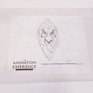 May include: A black and white pencil sketch of a lion's head with a fierce expression. The drawing is signed "The Animation Experience at Conservation Station" and dated "01/11/19".