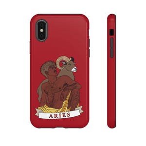 May include: A red smartphone case featuring an illustration of a person with short hair and a ram behind them. The person is draped in yellow fabric. Below the figure is a white banner with the red text ARIES. The case has a black camera cutout.