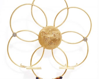 May include: Gold metal flower-shaped stand with a round center piece that says "Recharge your Soul". The stand has seven small stones around the outer edge.