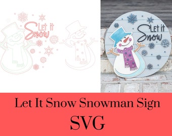 May include: A circular wooden sign featuring a snowman with a blue hat and a purple scarf, surrounded by blue snowflake cutouts and the text Let it Snow in black script. The design is also shown as a digital line drawing with red outlines.
