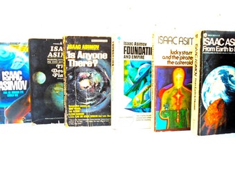 May include: A collection of vintage science fiction books by Isaac Asimov. The book covers feature vibrant colors, including yellow, blue, and purple, with titles like "Foundation and Empire" and "The Rest of the Robots."