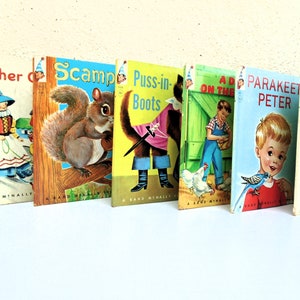 May include: A collection of six vintage children's books with colorful covers. The titles include "Mother Goose", "Scamp", "Puss-in-Boots", "A Dog on the Farm", "Parakeet Peter", and "The Children that lived in a Shoe".