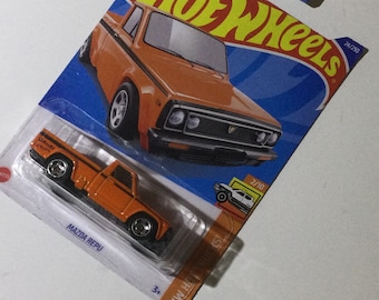Orange Mazda Repu Hot Wheels 1/64th scale.  Hotwheels die cast metal car, 24/250