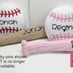 May include: Two plush baseballs and two plush baseball bats. One baseball has red stitching and the name Jonah, the other has pink stitching and the name Regina. One bat is tan with the name Jonah, the other is pink with the name Regina.