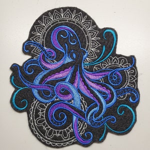 May include: Embroidered patch featuring a blue and purple octopus with swirling tentacles, surrounded by a black and white mandala design.