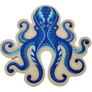 May include: Blue embroidered octopus patch with intricate details. The octopus has eight tentacles and a detailed head with green eyes. The patch is on a beige background.