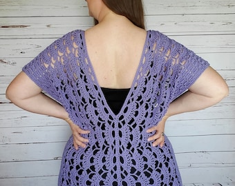 May include: A purple crochet dress with a deep V-neck back and short sleeves. The dress is made with a lacy pattern and has a loose fit.