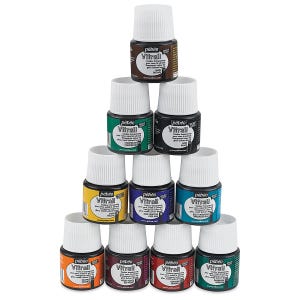 May include: A pyramid stack of ten small glass bottles of Pebeo Vitrail transparent paint for glass and metal. Each bottle features a white screw-top cap and a label displaying the brand name, color name, and a unique identification number.