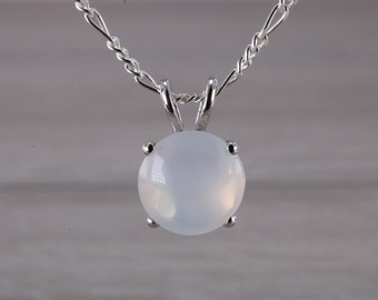 May include: A silver chain necklace with a white moonstone pendant.