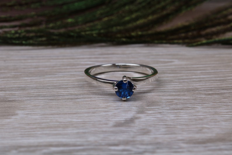 Silver solitaire ring with four claw twist setting of beautiful round royal blue sapphire C Z image 1