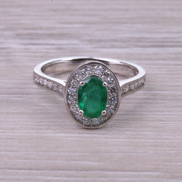 Emerald and Halo Diamond set Platinum Ring