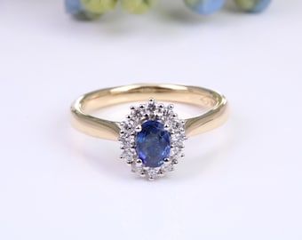 May include: A gold ring with a blue sapphire surrounded by a halo of diamonds.
