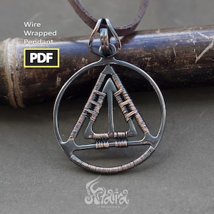 May include: A silver wire wrapped pendant in the shape of a triangle inside a circle. The pendant is on a brown leather cord.