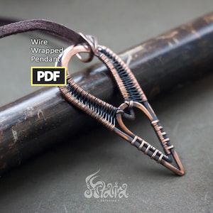 May include: A copper and black wire wrapped pendant in the shape of a heart with a pointed tip. The pendant is hanging from a brown leather cord. The text "Wire Wrapped Pendant PDF" is visible in the image.
