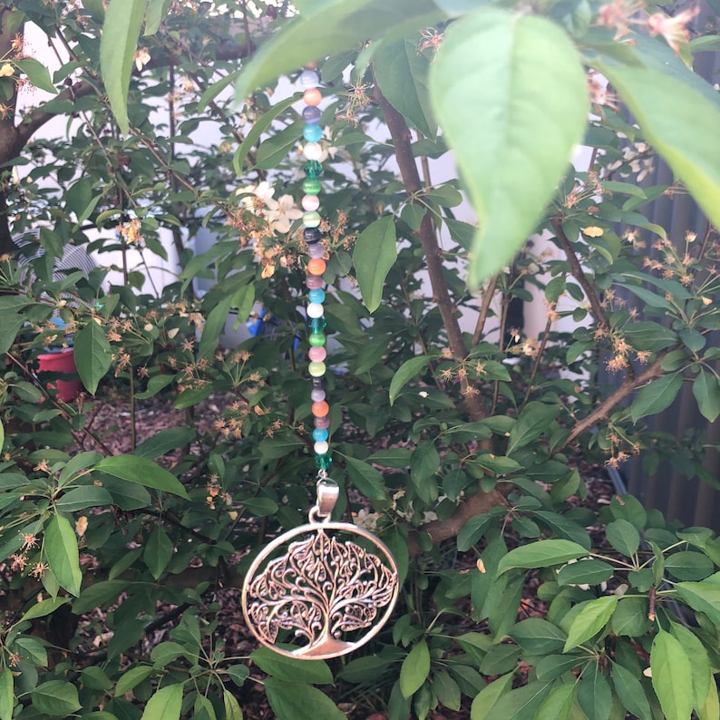 beaded wooden tree of life silver tree of life silver heart with silver tassels silver cross. Suncatchers