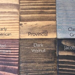 May include: Six wood stain samples showing different colors and wood grain patterns. The colors are Early American, Provincial, Classic Grey, Red Mahogany, Dark Walnut, and Jacobean.