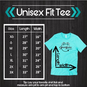 May include: A size chart for a unisex t-shirt, showing measurements in inches for length and width. The chart includes sizes XS through 3X. The chart is on a dark wood background. The text "Unisex Fit Tee" is at the top of the chart. A light blue t-shirt is shown to the right of the chart, with arrows indicating length and width.