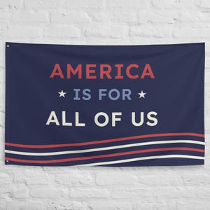 May include: A navy blue flag with white and red stripes. The flag has the text "AMERICA IS FOR ALL OF US" in white and red lettering.