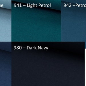 May include: A color palette featuring five fabric swatches in shades of blue. The swatches are labeled with color names and numbers: Dusty Blue, Light Petrol, Petrol, Denim, and Dark Navy. The fabric appears to have a subtle texture.