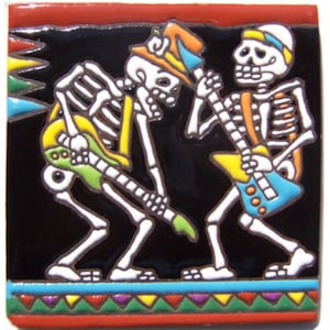 May include: Two skeletons playing electric guitars. The skeletons are wearing hats and have colorful bones. The guitars are yellow, green, and blue. The background is black with a colorful border.