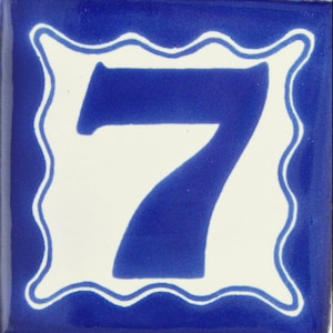 May include: A blue ceramic tile with a white border and a white number 7 in the center. The tile is a decorative house number.