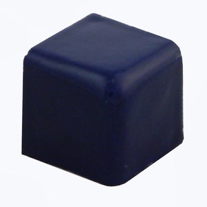 May include: A solid, navy blue cube with rounded edges. The object is a simple geometric shape, likely a component or a decorative element. The smooth surface reflects light, highlighting its form against a white background.